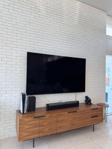 Wall-mounted television installed on a brick wall by TV Solutions of El Paso