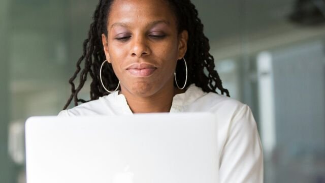 Founder working on a laptop while planning a company launch